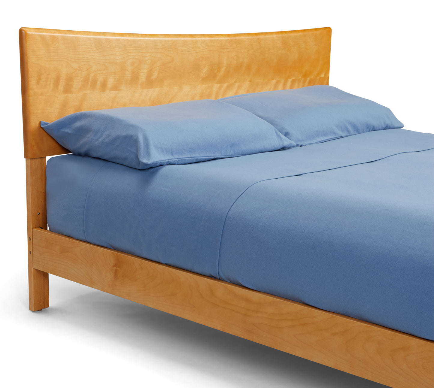 Close-up of headboard and mattress with blue bedding